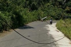 Tiang Listrik Tumbang dan Kabel Melintang di Jalan ke Kawasan Wisata Danau Ranau